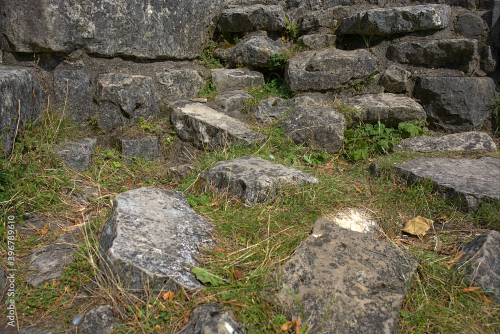 low angle view of rocks from ruins on a grassy ground