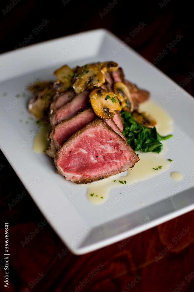 Steak and potatoes. Grade A grass fed angus beef steaks. Tenderloin, filet mignon, New York strip, bone in rib-eye grilled medium rare on outdoor wood-fired grill. Classic American steakhouse entree. Steak and potatoes. Grade A grass fed angus beef steaks. Tenderloin, filet mignon, New York strip, bone in rib-eye grilled medium rare on outdoor wood-fired grill. Classic American steakhouse entree.