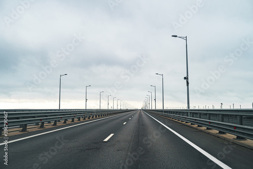 Empty highway with asphalt road and cloudy sky © fotofabrika