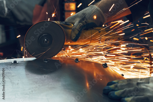 Metal processing with angle grinder. Sparks in metalworking