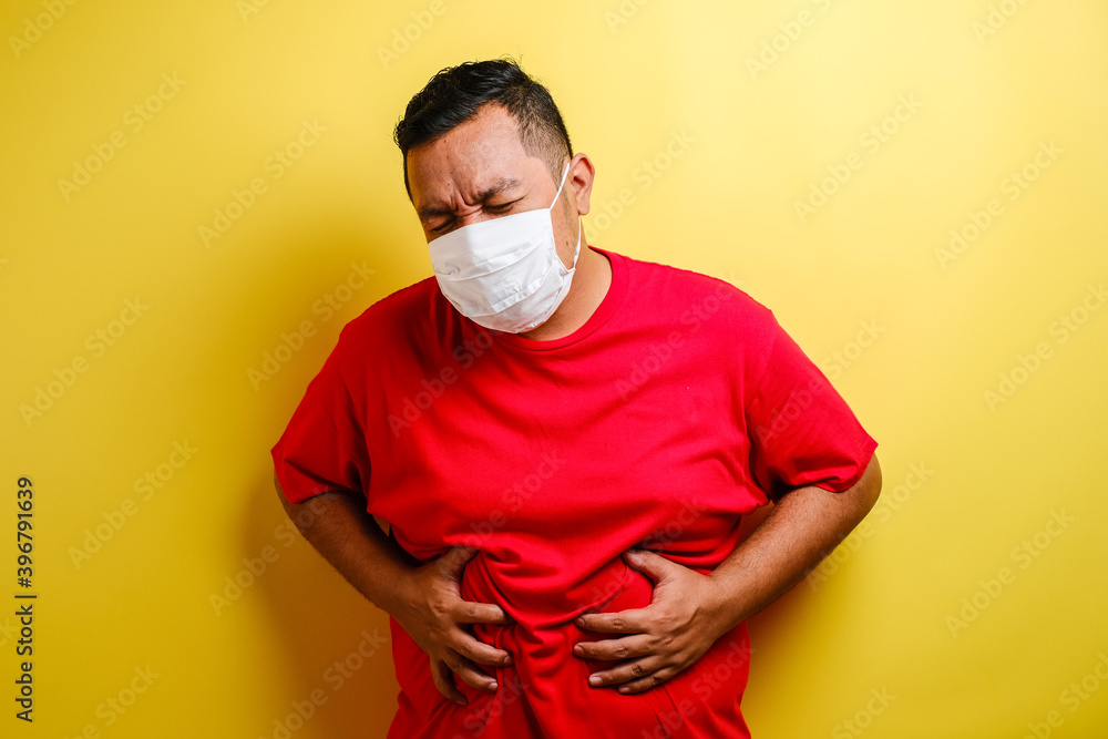 Asian man feeling pain on his stomach Asian man feeling pain on his stomach