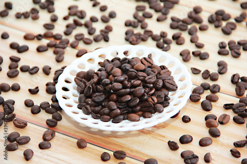 natural black coffee beans in a decorative plate