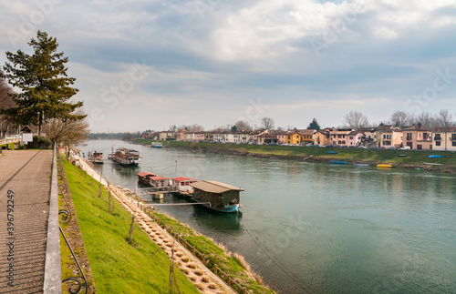 Landscape of Ticino river in Pavia with boats and colorful houses, Lombardy, Italy