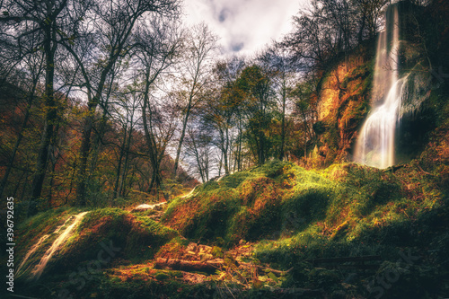 Beautiful waterfall in the forest. Germany Black Forest. Long quote exposure and trees. Cliff river