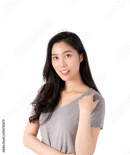 Portrait of a smiling Asian business woman looking at camera isolated over white background. Happy Young Asian Woman with blank copy space. Beauty emotion facial expression.  © Avirut S.