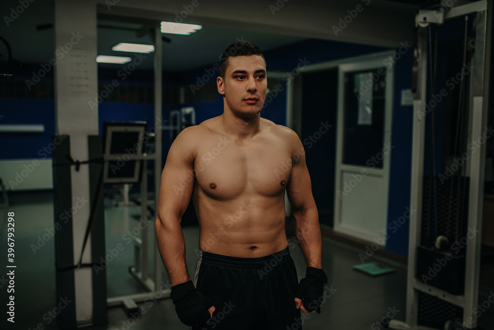 Fitness shaped muscle man posing on gym. Caucasian, instructor. Fitness shaped muscle man posing on gym. Caucasian, instructor.
