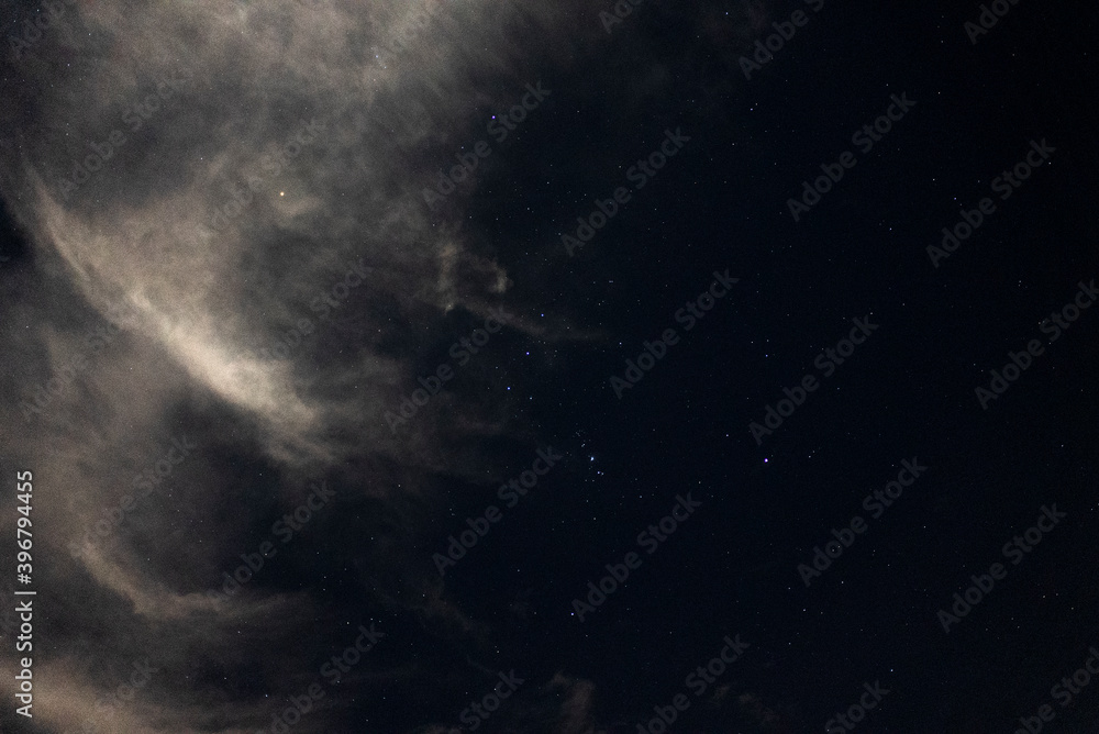 Hazy Clouds in the Night Sky with Twinkling Beautiful Stars and Constellations Hazy Clouds in the Night Sky with Twinkling Beautiful Stars and Constellations