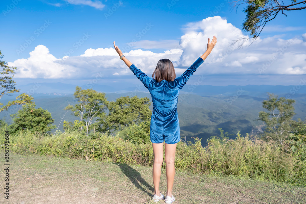 Fototapeta premium The image behind the women raise their arms looked at the mountains and cloud at Doi Samer Dao , Nan in Thailand