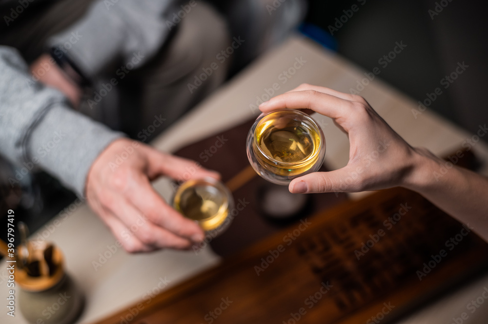 Romantic date in a tea house. A man and a woman drink tea at a table with bamboo tea accessories. The view from the top Romantic date in a tea house. A man and a woman drink tea at a table with bamboo tea accessories. The view from the top