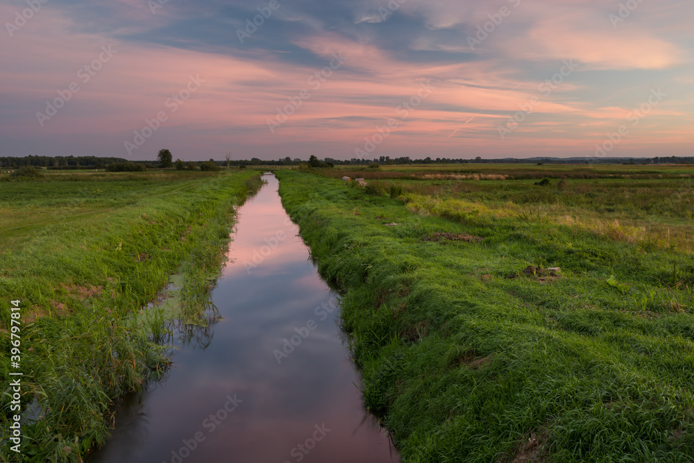 Reflection of the colorful sky in a calm river Reflection of the colorful sky in a calm river