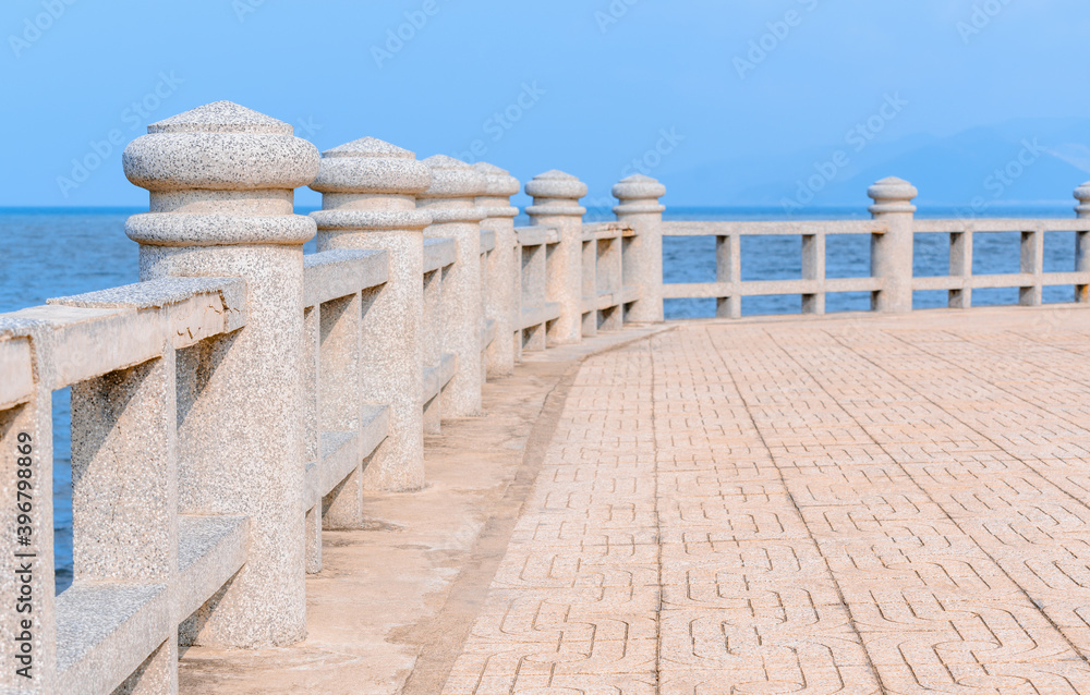 Fototapeta premium Concrete columns overlooking the blue sea.