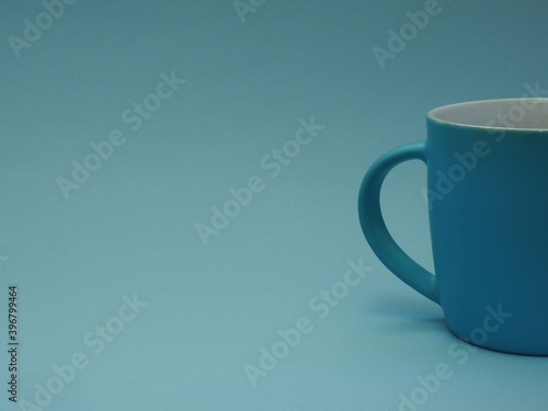 Simple blue cup without label on blue background