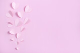 .top view of paper hearts on pink background