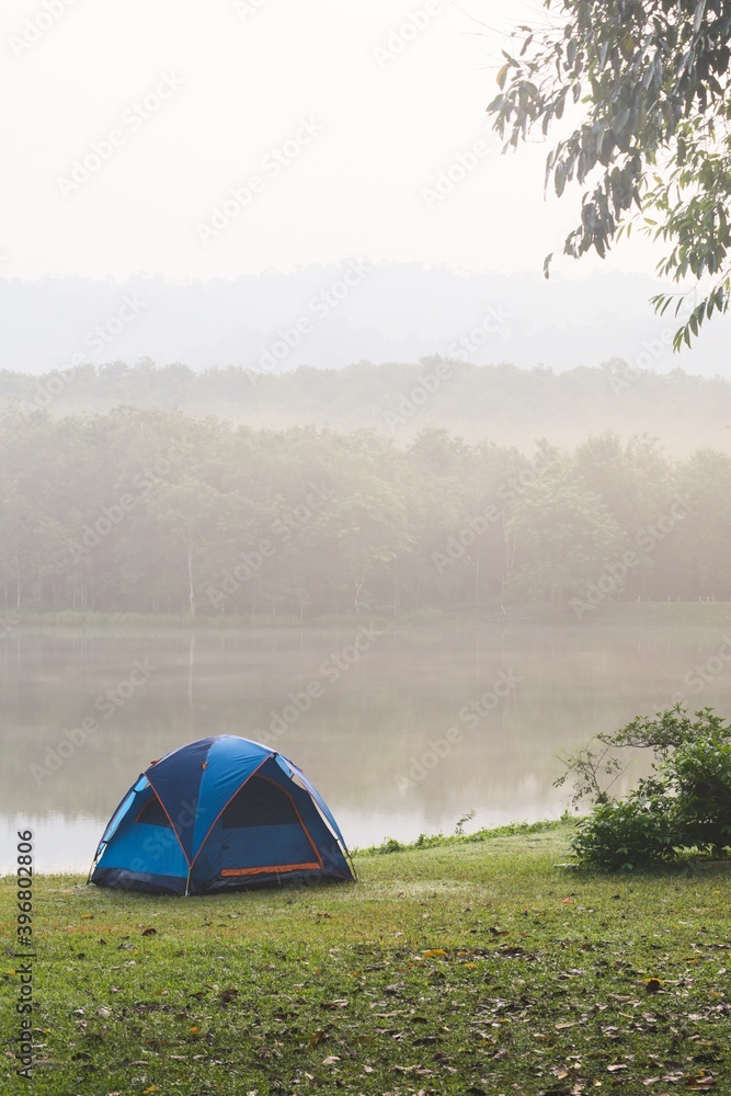 Camping tent by a lake with mist at sunrise Jedkod-Pongkonsao Natural Study in Saraburi Thailand	