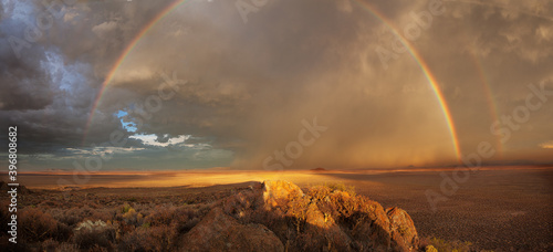 Photography Panoramic view of a double rainbow with a thunderstorm over the Greater Karoo in