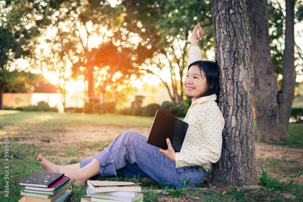 Asian female high school happy using tablet e leaning online class. selective and soft focus. Asian female high school happy using tablet e leaning online class. selective and soft focus.