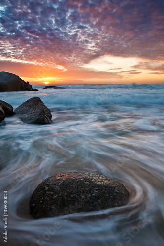 A Vertical wide angle view of a spectacular sunset as seen from a very popular beach in Cape Town South Africa