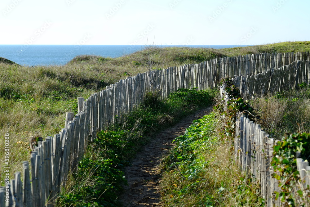 A small path to the ocean shore. Batz sur mer during a sunny day of november.