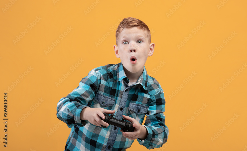Excited boy playing video game with joystick, copy space Excited boy playing video game with joystick, copy space
