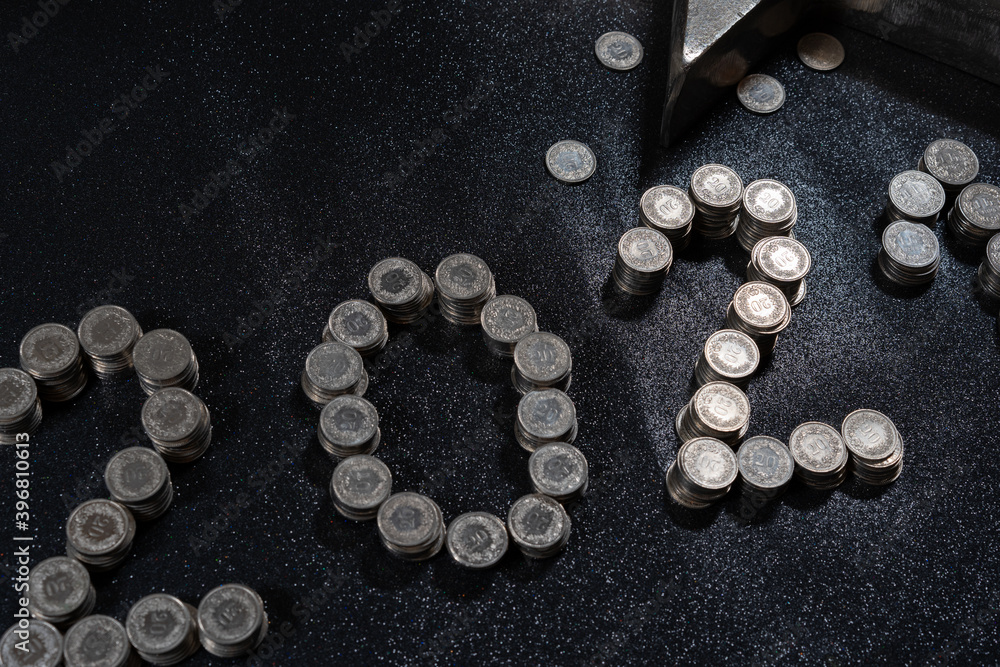 High angle view of New Years 2021 as Swiss coins on a black background. High angle view of New Years 2021 as Swiss coins on a black background.