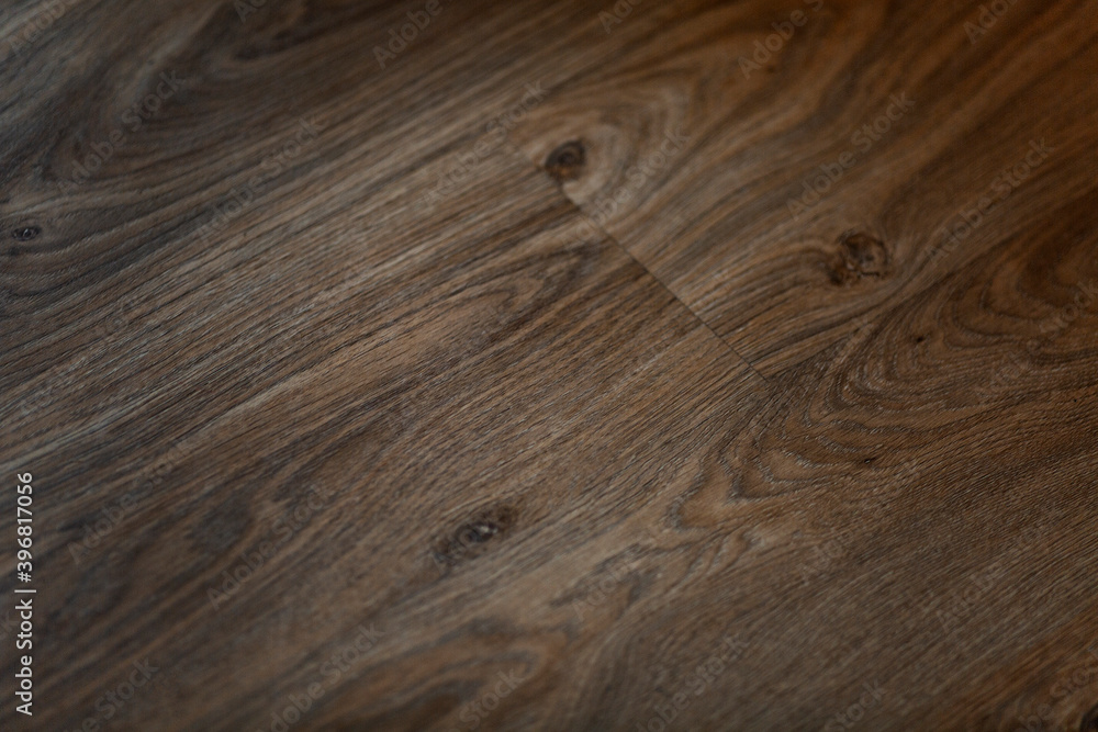 Fototapeta premium The surface of the brown parquet board. Background. Space for text.