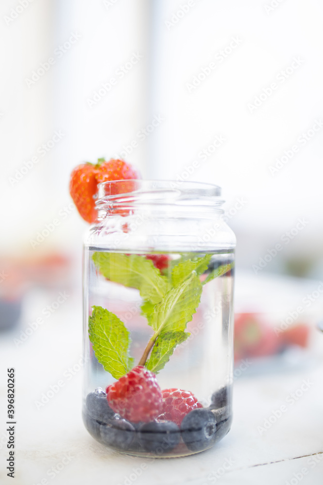 Strawberry on the edge of a mint and berries drink Strawberry on the edge of a mint and berries drink