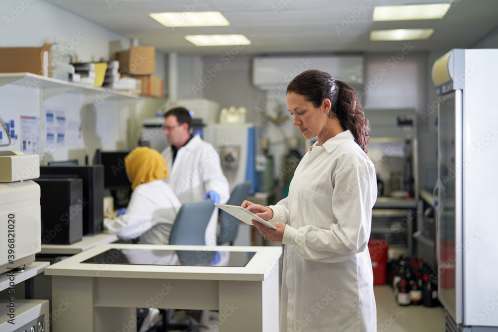 Female scientist using digital tablet in laboratory Female scientist using digital tablet in laboratory