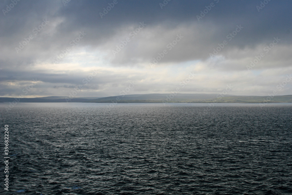 clouds over the sea with view of the Shetland isles