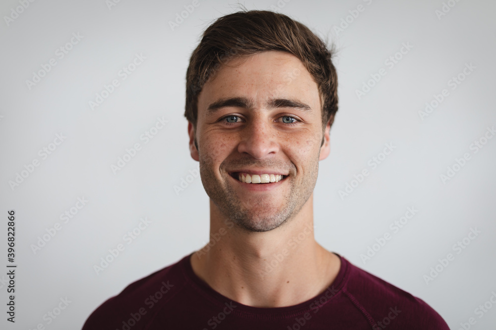 Fototapeta premium Portrait of caucasian man smiling against grey background
