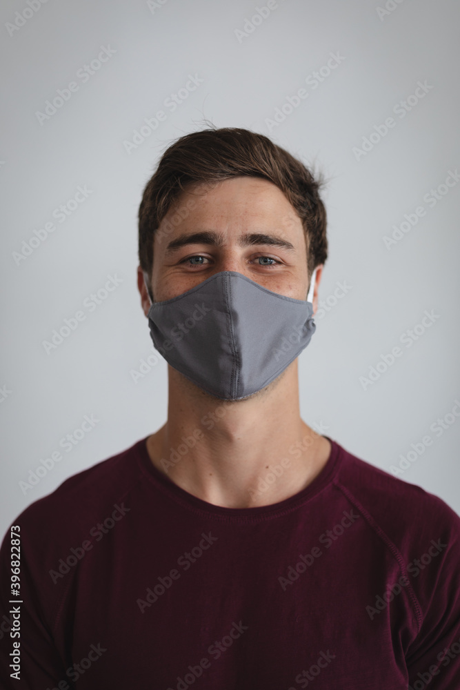 Portrait of caucasian man wearing face mask against grey background Portrait of caucasian man wearing face mask against grey background