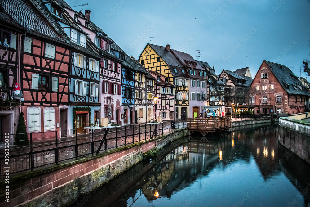 Reflections in the river of the colored houses of Colmar at dawn at Christmas