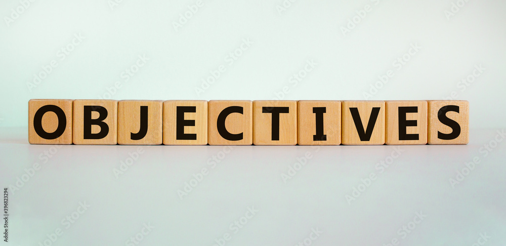 Objectives symbol. Word 'objectives' written on wooden blocks. Business and objectives concept. Copy space. Beautiful white background. Objectives symbol. Word 'objectives' written on wooden blocks. Business and objectives concept. Copy space. Beautiful white background.