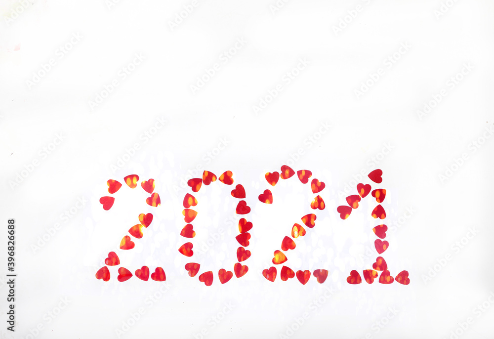2021 lined with red glittering hearts on white background. New Year. Place for text. Copy space.