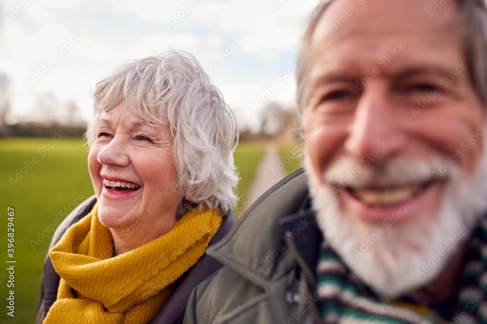 Portrait Of Loving Senior Couple Enjoying Autumn Or Winter Walk Through Park Together Portrait Of Loving Senior Couple Enjoying Autumn Or Winter Walk Through Park Together