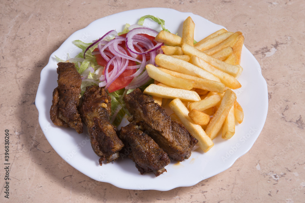 Half rack of barbecue pork ribs with french fries. Half rack of barbecue pork ribs with french fries.