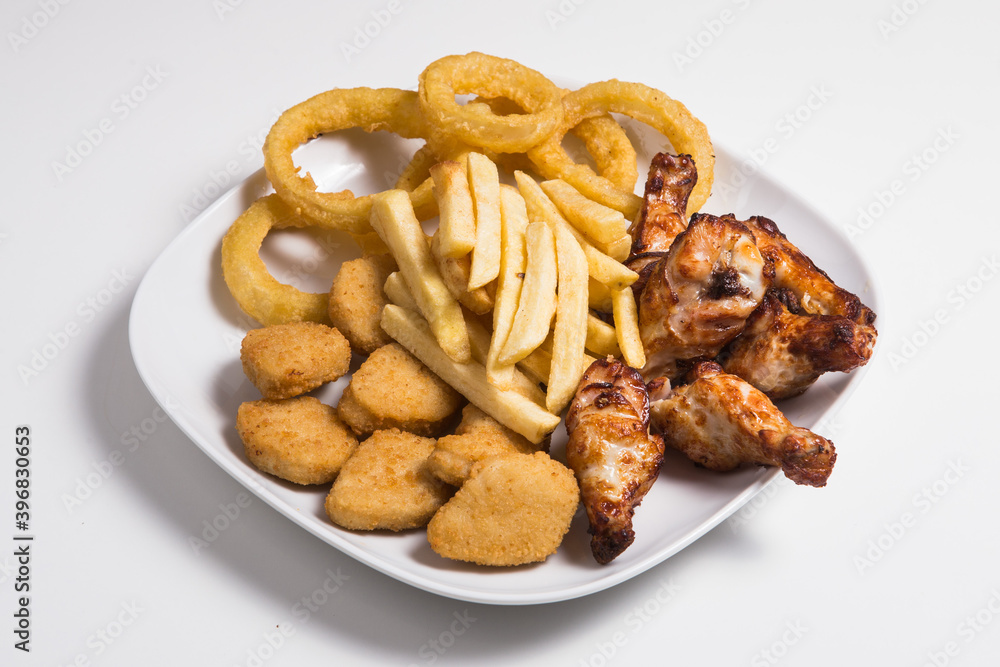 Combo plate with chicken wings, nuggets, squids and french fries Combo plate with chicken wings, nuggets, squids and french fries