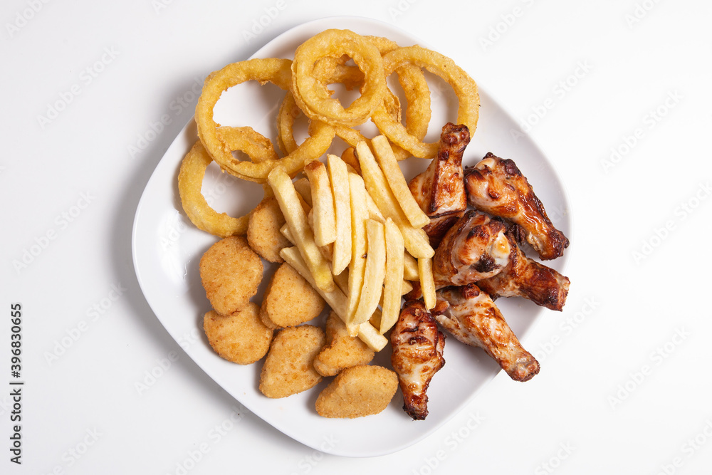 Combo plate with chicken wings, nuggets, squids and french fries Combo plate with chicken wings, nuggets, squids and french fries