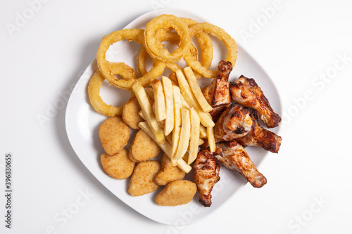 Combo plate with chicken wings, nuggets, squids and french fries