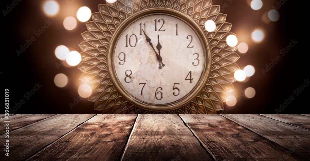 Wooden holiday empty table, night view, blurred bokeh lights background. New Year's classic clock, New Year. Wooden holiday empty table, night view, blurred bokeh lights background. New Year's classic clock, New Year.