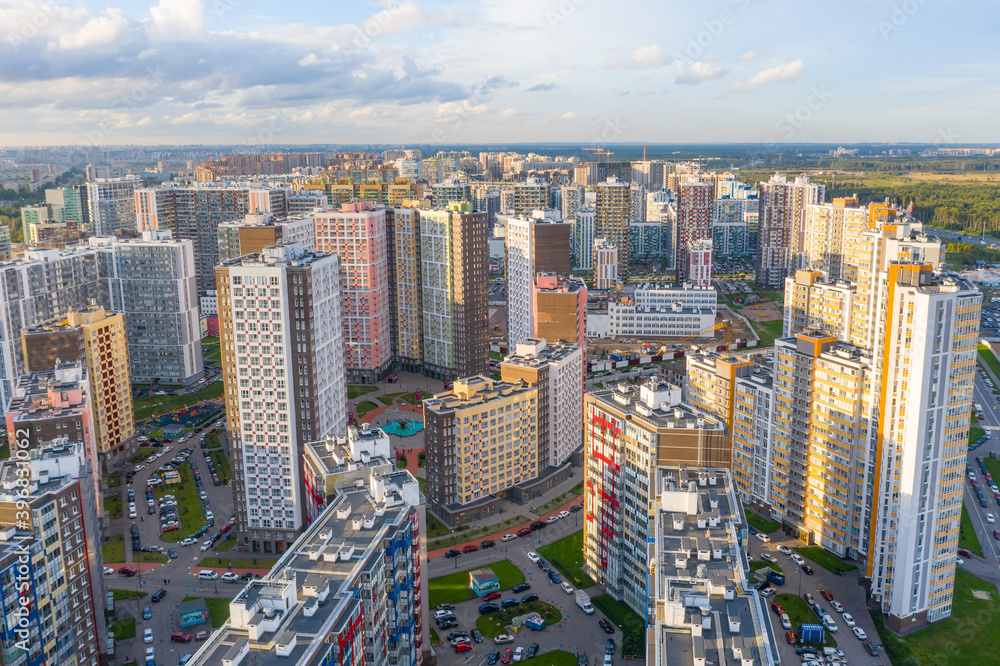 Panoramic aerial view of the city with multi-storey residential buildings and highways.