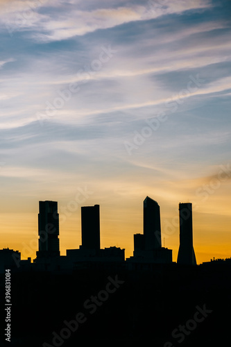 Cuatro Torres Business Area Madrid skyline at sunset with high contrast in vertical