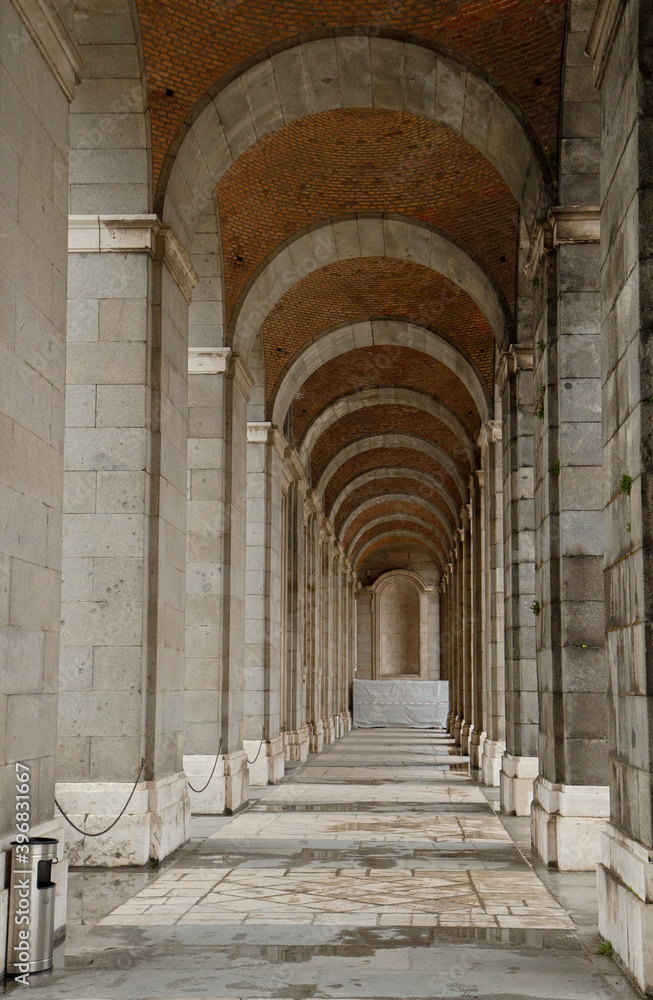 Architecture and design. View of the beautiful passage, columns and ceiling made of concrete blocks in the Royal Palace of Madrid, Spain. 