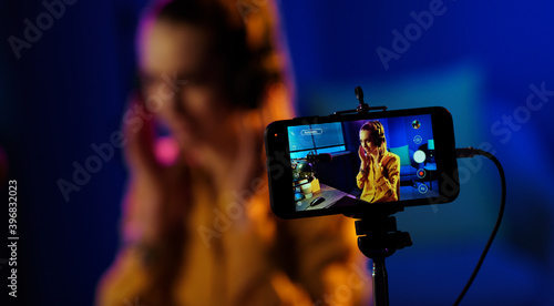 Young woman streaming a live video © StockPhotoPro