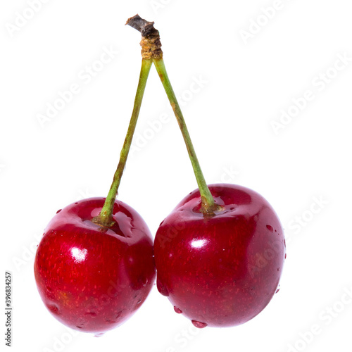 Two organic sweet cherries isolated on a white background.
