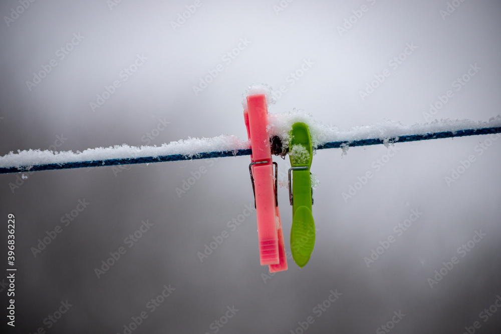 clothes peg on a clothesline in snowy winter day clothes peg on a clothesline in snowy winter day