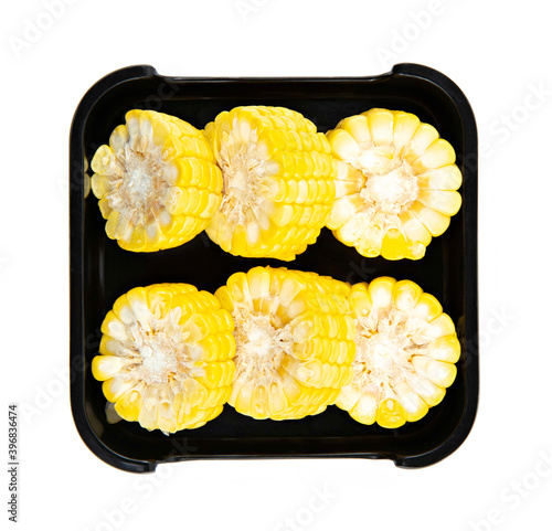 fresh Sweet corn in blsck dish isolated on white background, shabu, hot pot ingredients. photo