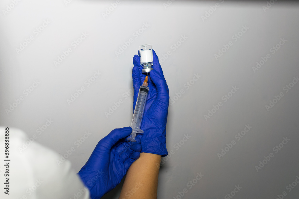 two hands holding a vaccine sample two hands holding a vaccine sample