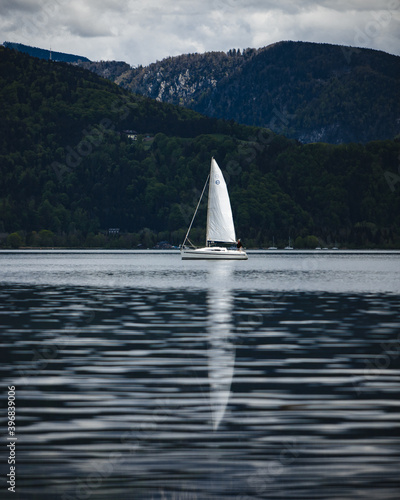 Sailing boat on a lake with mountains in the background