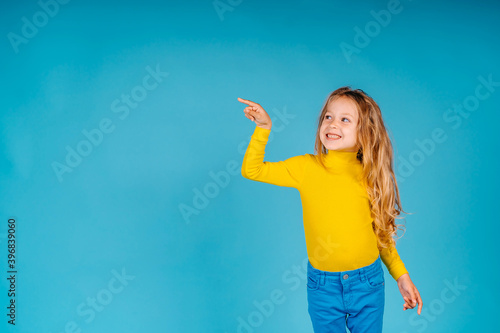 Child girl shows gesture on blue background