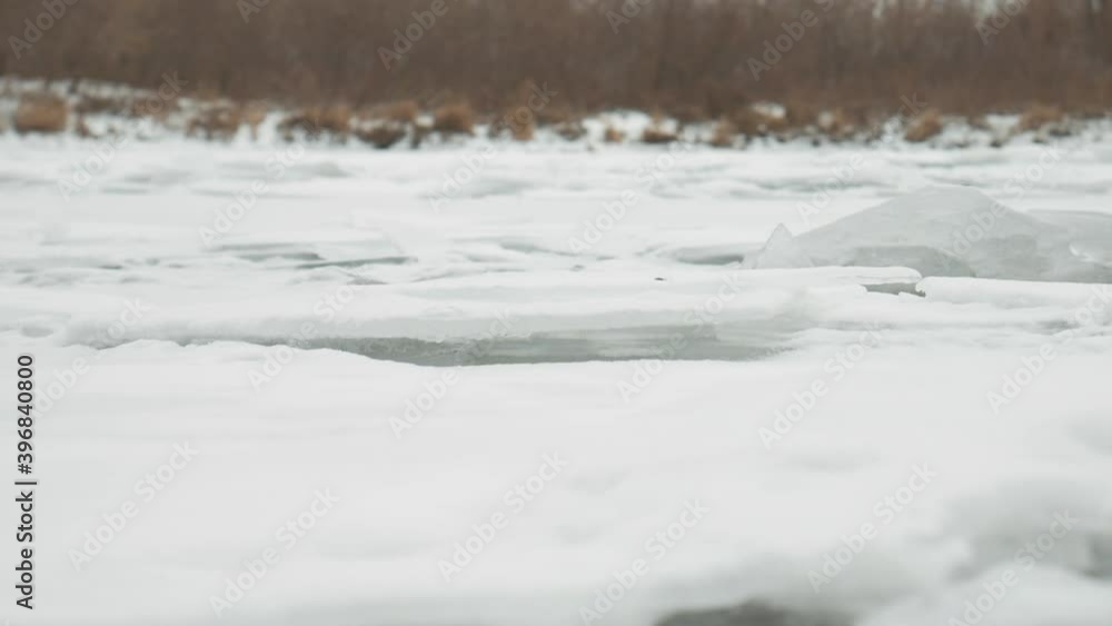 Close-up of a frozen river with frozen ice cracks Close-up of a frozen river with frozen ice cracks